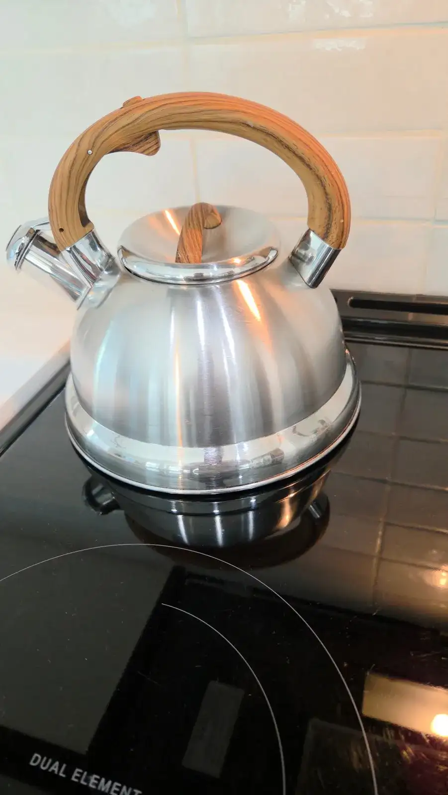 After: the same kettle polished and shining on the stove
