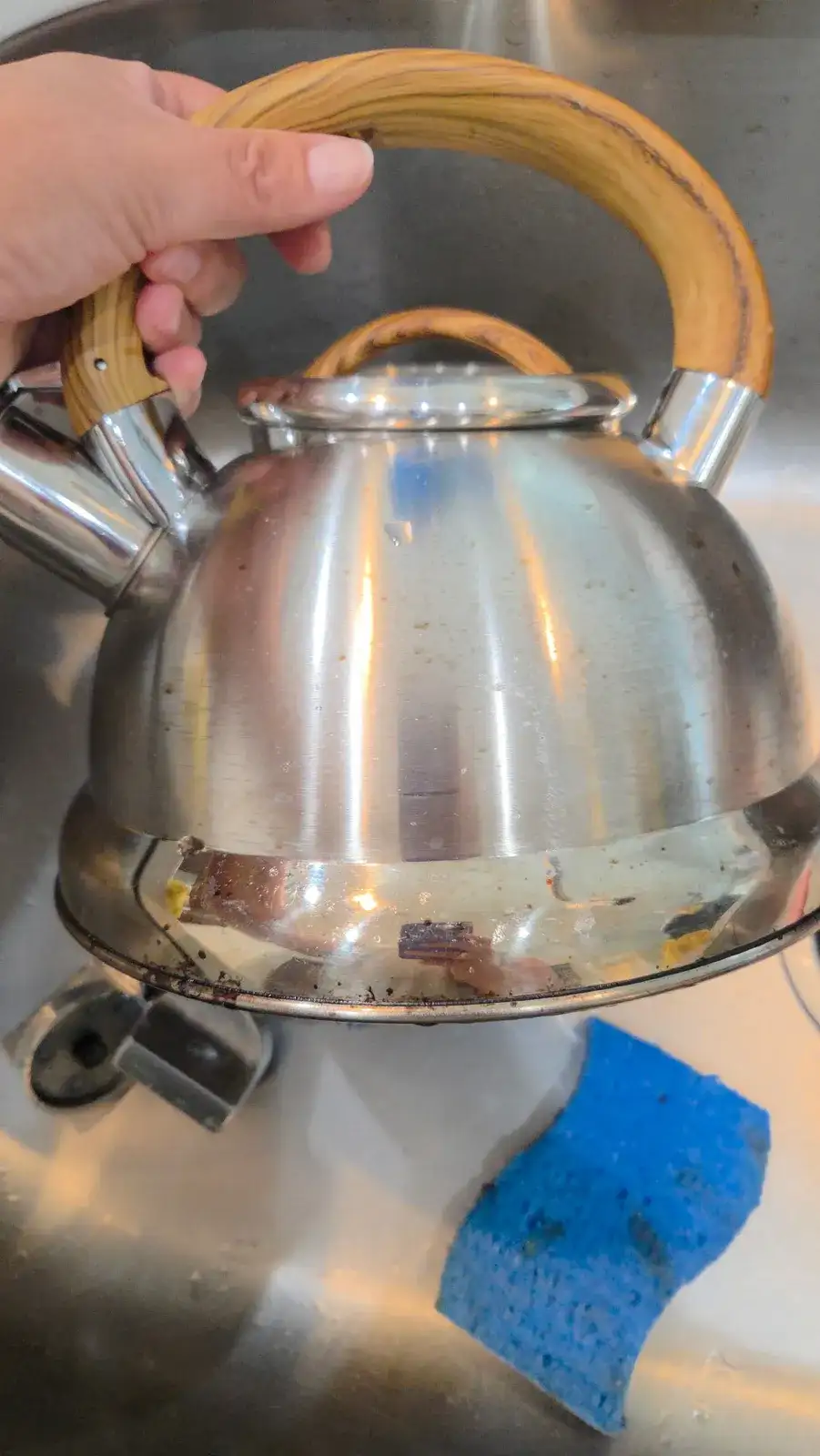 Before: steel tea kettle with burnt-on stains around the base
