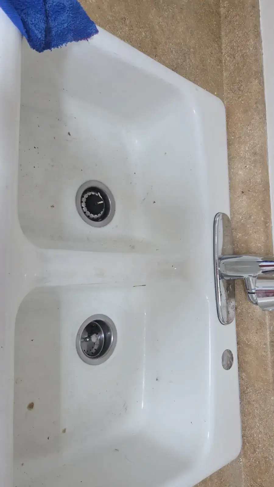 Before: white double kitchen sink with stains and water spots