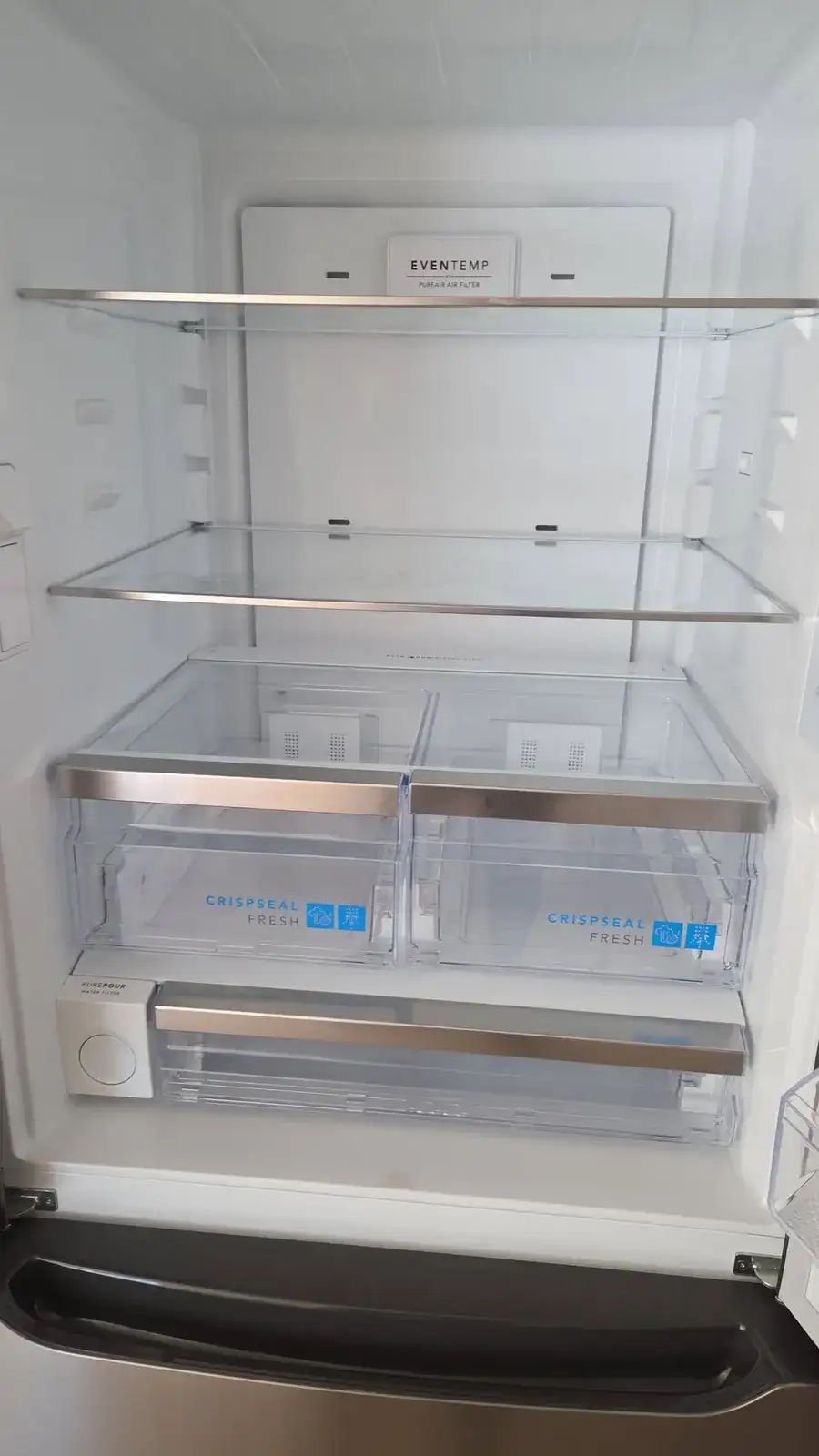 Empty refrigerator wiped clean inside, shelves and drawers included