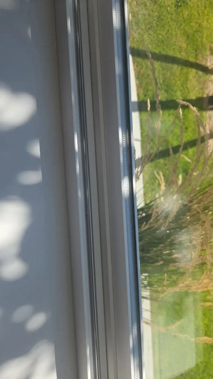 Clean window frame and track with sunlight coming through